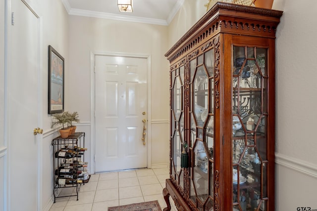 foyer entrance featuring ornamental molding and light tile patterned floors