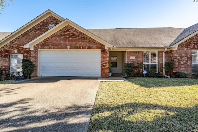 ranch-style house featuring a garage and a front yard