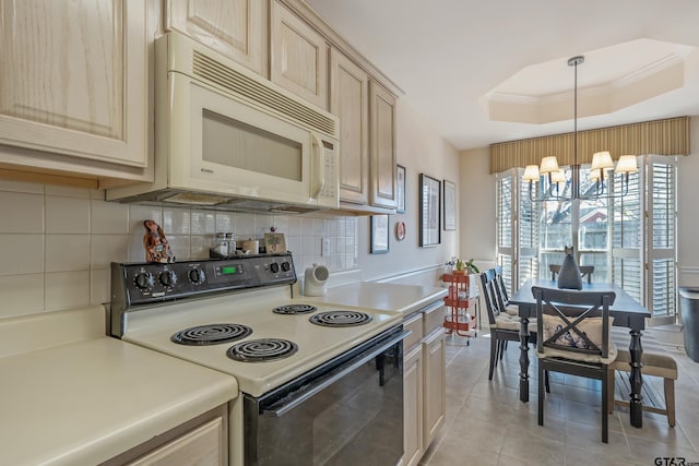 kitchen with backsplash, range with electric cooktop, light brown cabinetry, decorative light fixtures, and a raised ceiling