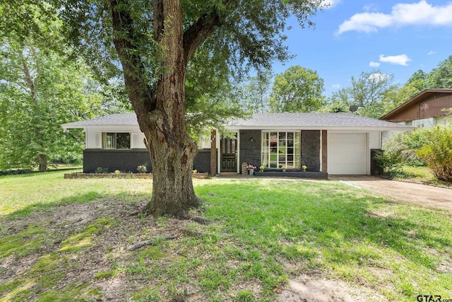 412 W 25th St, Tyler, TX 75702 - view of front of property with a garage, concrete driveway, a front lawn, and stone siding