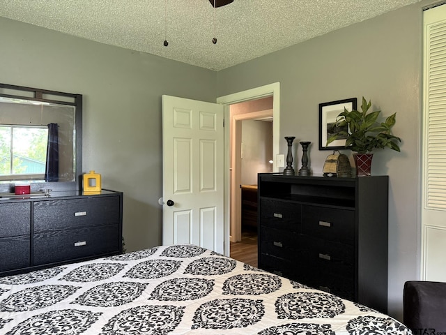 412 W 25th St, Tyler, TX 75702 - bedroom with a textured ceiling, wood finished floors, and a closet