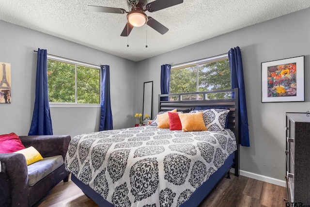 412 W 25th St, Tyler, TX 75702 - bedroom with wood finished floors, a ceiling fan, and a textured ceiling
