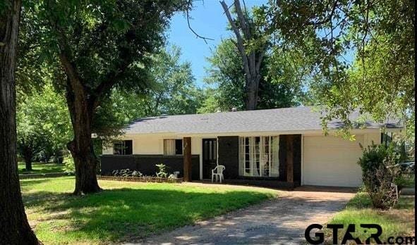 412 W 25th St, Tyler, TX 75702 - ranch-style house with a garage, driveway, and a front yard