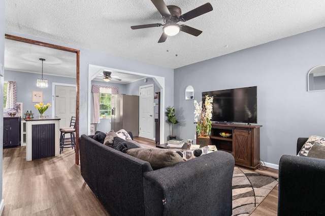 412 W 25th St, Tyler, TX 75702 - living area with a ceiling fan, wood finished floors, and a textured ceiling