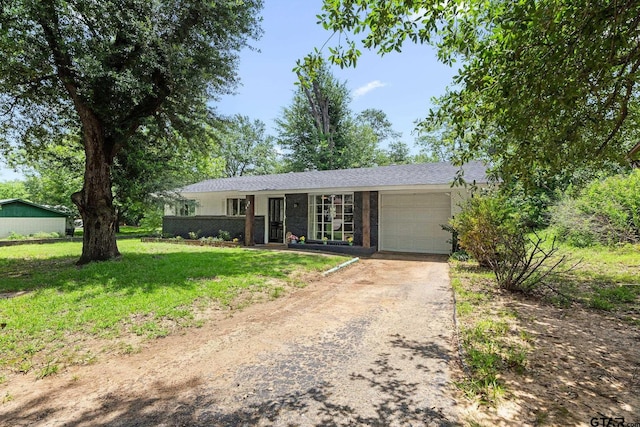 412 W 25th St, Tyler, TX 75702 - ranch-style home featuring an attached garage, asphalt driveway, and a front lawn