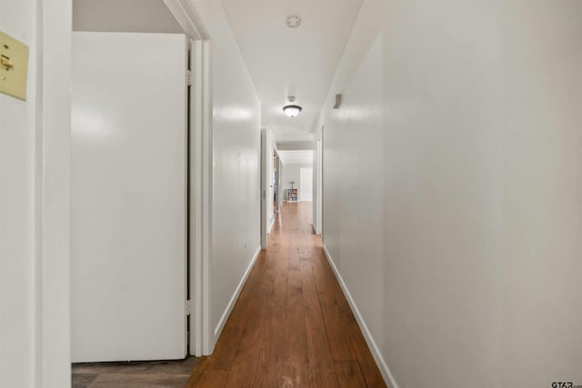 corridor with dark wood-type flooring