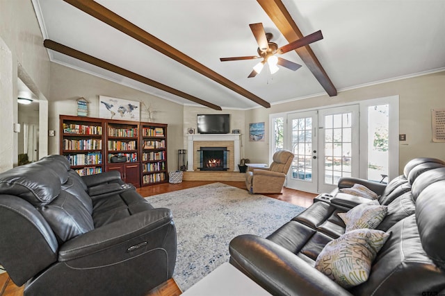 living room featuring hardwood / wood-style flooring, ceiling fan, beam ceiling, and french doors