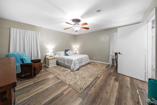 bedroom with ceiling fan and dark hardwood / wood-style floors