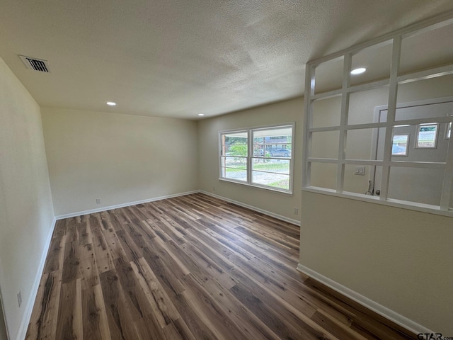 320 Northcrest Dr, Tyler, TX 75702 - spare room with dark wood-style flooring, a textured ceiling, and recessed lighting