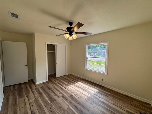 320 Northcrest Dr, Tyler, TX 75702 - unfurnished bedroom with a closet, wood finished floors, and a ceiling fan