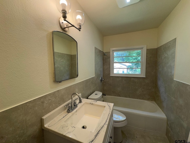 320 Northcrest Dr, Tyler, TX 75702 - full bathroom with tile walls, vanity, tub / shower combination, and wainscoting