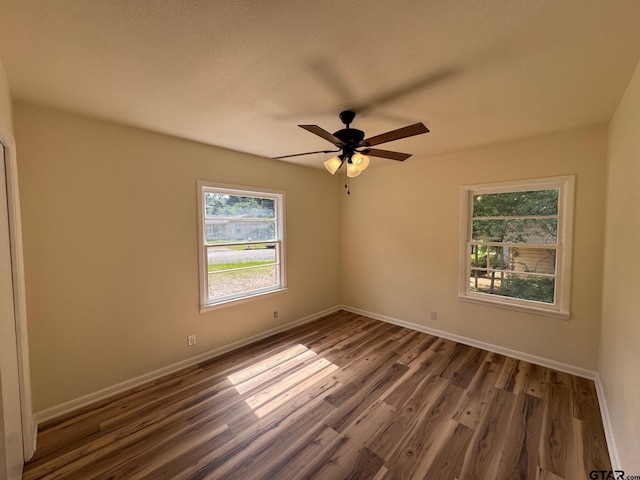 320 Northcrest Dr, Tyler, TX 75702 - spare room featuring healthy amount of natural light, wood finished floors, and a ceiling fan