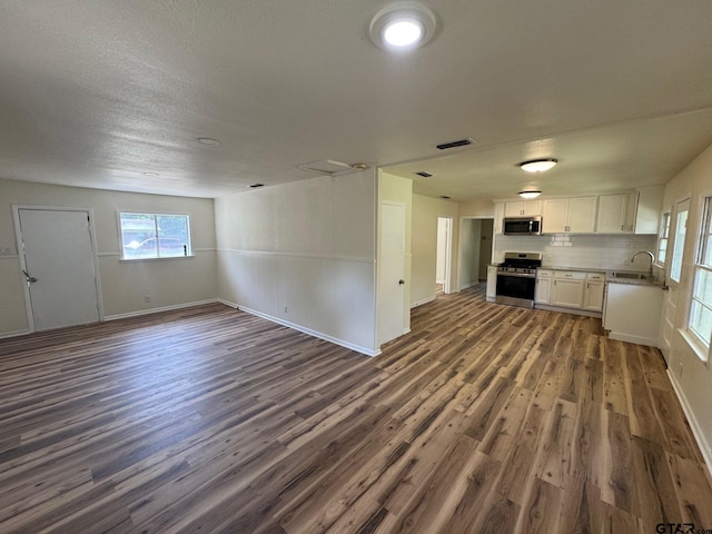 320 Northcrest Dr, Tyler, TX 75702 - unfurnished living room featuring dark wood-type flooring and a sink