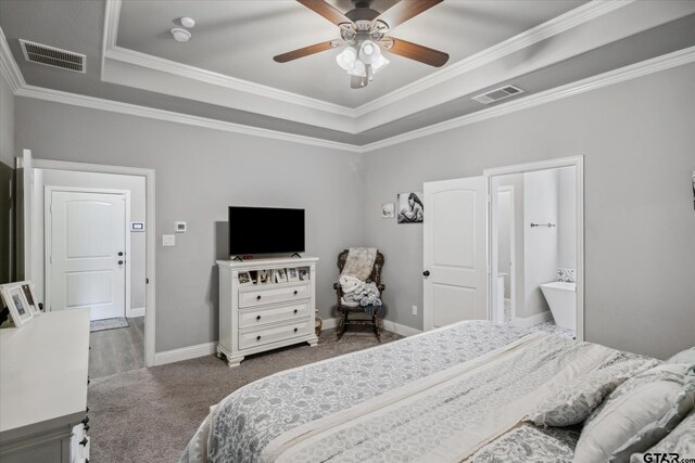 bedroom featuring baseboards, visible vents, and a raised ceiling