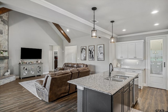 kitchen with lofted ceiling with beams, dishwasher, dark wood-type flooring, white cabinetry, and a sink