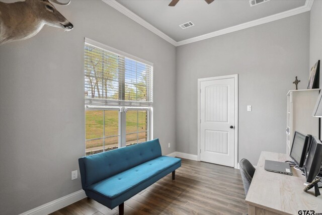 office featuring visible vents, crown molding, baseboards, and wood finished floors