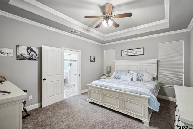 bedroom with a tray ceiling, ornamental molding, baseboards, carpet floors, and visible vents