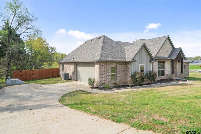 view of property exterior with fence, board and batten siding, driveway, central AC unit, and brick siding