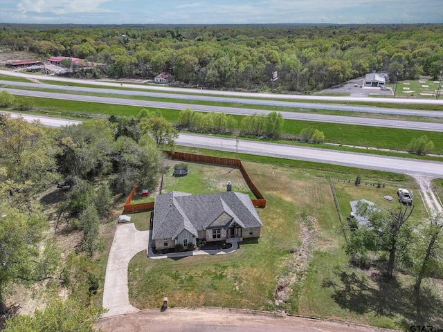 bird's eye view with a wooded view