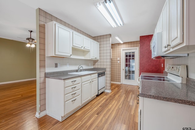 kitchen featuring white appliances, sink, light hardwood / wood-style flooring, ceiling fan, and white cabinetry