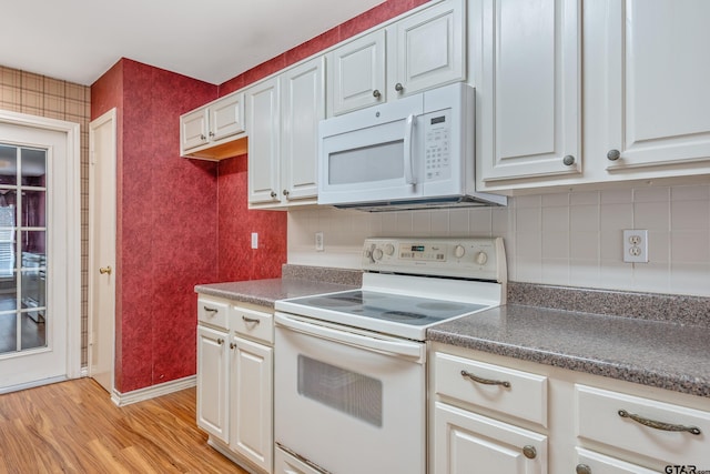 kitchen featuring white appliances, light hardwood / wood-style flooring, and white cabinetry