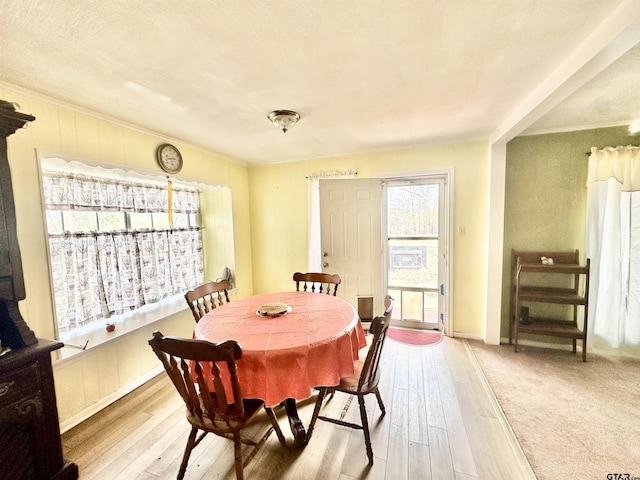 dining room with ornamental molding and wood finished floors