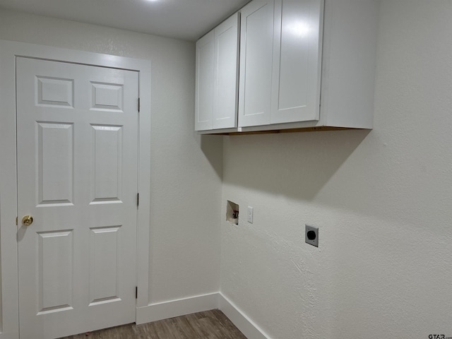 180 Lovers Ln, Alto, TX 75925 - laundry area with hookup for an electric dryer, cabinet space, wood finished floors, and washer hookup