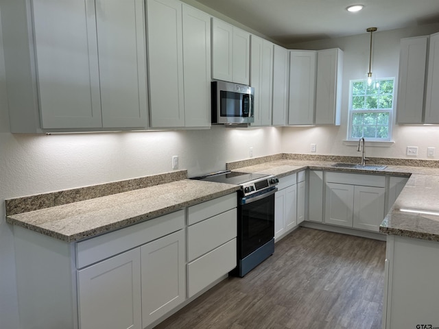180 Lovers Ln, Alto, TX 75925 - kitchen with appliances with stainless steel finishes, wood finished floors, white cabinets, light stone counters, and recessed lighting