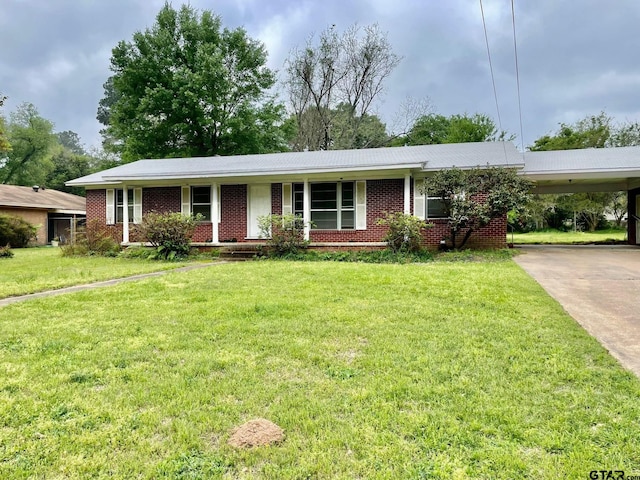 ranch-style house featuring a front yard and a carport