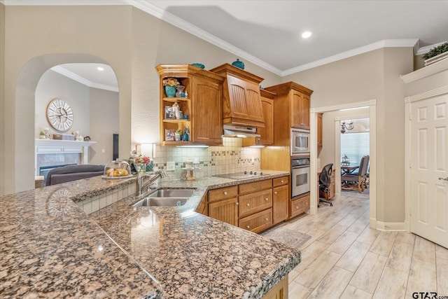 3109 Granbury Ct, Tyler, TX 75707 - kitchen with stainless steel appliances, open shelves, under cabinet range hood, ornamental molding, and tasteful backsplash