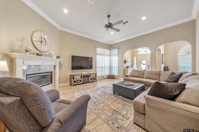 3109 Granbury Ct, Tyler, TX 75707 - living area featuring arched walkways, ceiling fan, a tiled fireplace, recessed lighting, and wood finished floors