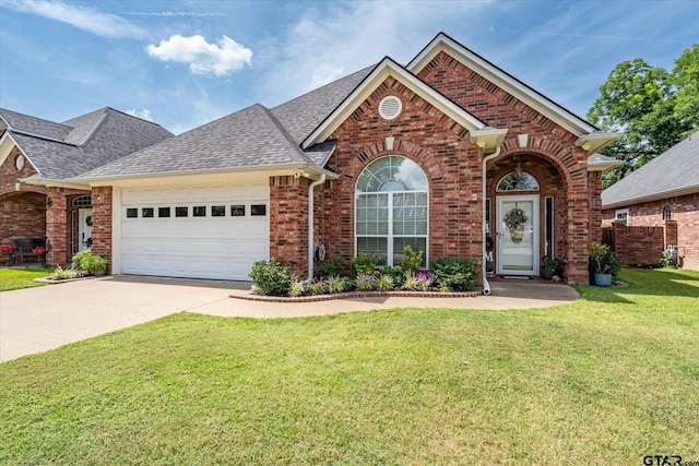 3109 Granbury Ct, Tyler, TX 75707 - traditional-style house featuring brick siding, a shingled roof, a garage, concrete driveway, and a front lawn