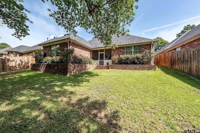 3109 Granbury Ct, Tyler, TX 75707 - rear view of house with a fenced backyard, brick siding, a sunroom, and a shingled roof