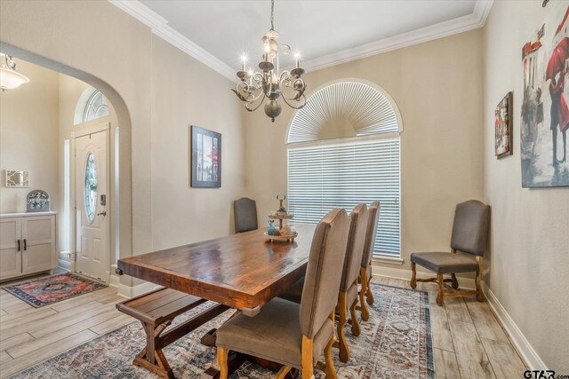 3109 Granbury Ct, Tyler, TX 75707 - dining space with light wood-style flooring, arched walkways, a chandelier, and ornamental molding