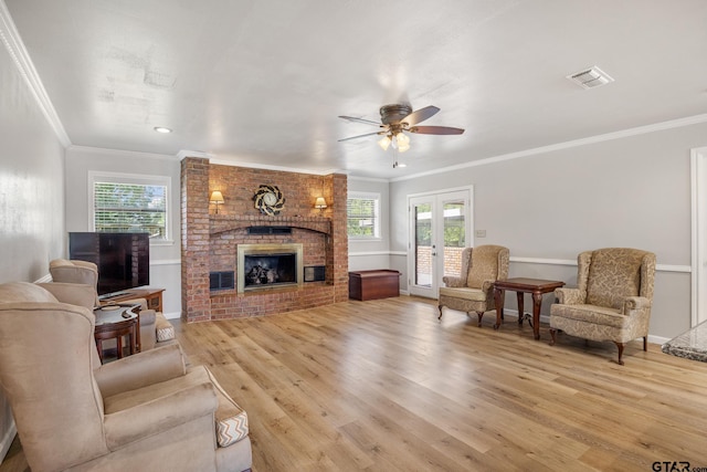 104 W Perry St, Frankston, TX 75763 - living area featuring ceiling fan, light wood finished floors, a brick fireplace, and ornamental molding
