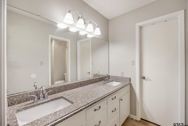 104 W Perry St, Frankston, TX 75763 - bathroom featuring double vanity and wood finished floors