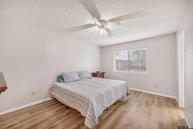 104 W Perry St, Frankston, TX 75763 - bedroom with light wood-style floors, a ceiling fan, and a textured ceiling