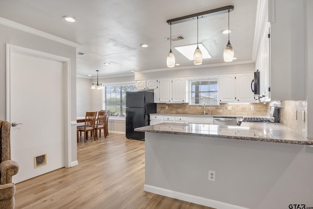 104 W Perry St, Frankston, TX 75763 - kitchen with freestanding refrigerator, range, crown molding, light stone countertops, and white cabinets