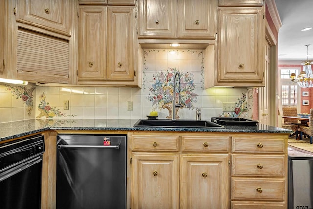 kitchen with dark stone countertops, sink, an inviting chandelier, and dishwasher