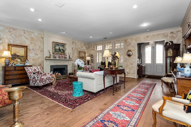 living room featuring light hardwood / wood-style floors and ornamental molding