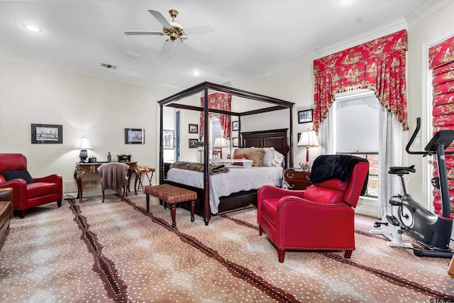 carpeted bedroom with ornamental molding and ceiling fan