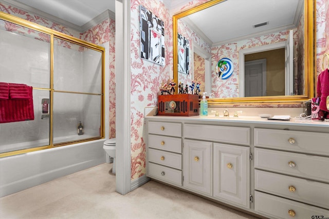 full bathroom featuring toilet, combined bath / shower with glass door, vanity, and ornamental molding