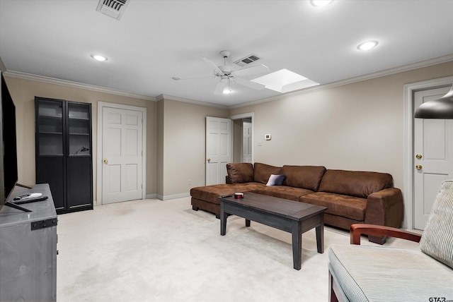 living room featuring carpet, a skylight, ceiling fan, and crown molding