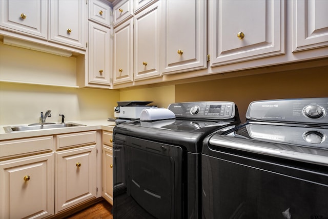 washroom featuring dark wood-type flooring, cabinets, sink, and independent washer and dryer