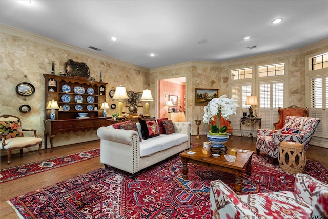 living room featuring wood-type flooring and ornamental molding