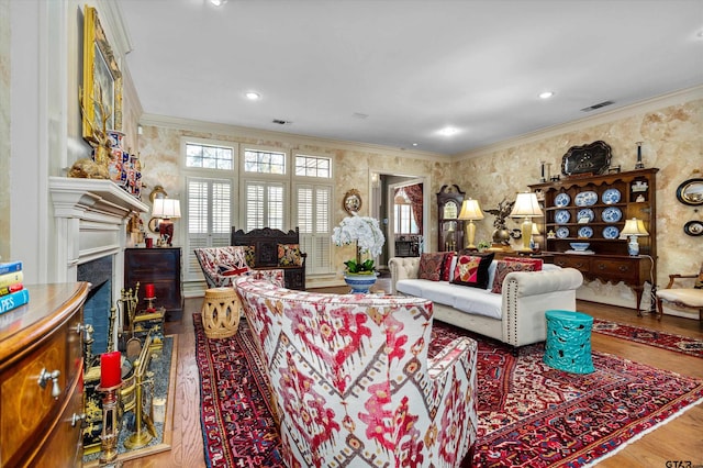 living room with hardwood / wood-style flooring and crown molding