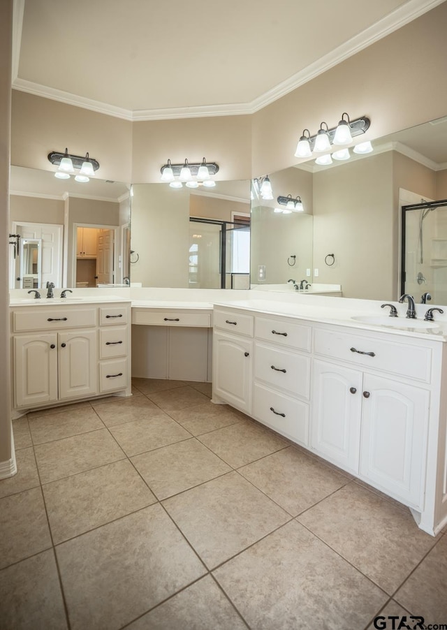 bathroom with a shower with shower door, vanity, tile patterned floors, and crown molding