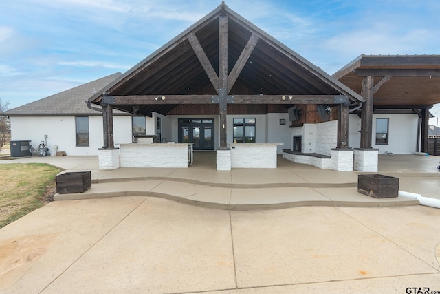 exterior space featuring cooling unit, french doors, and exterior kitchen