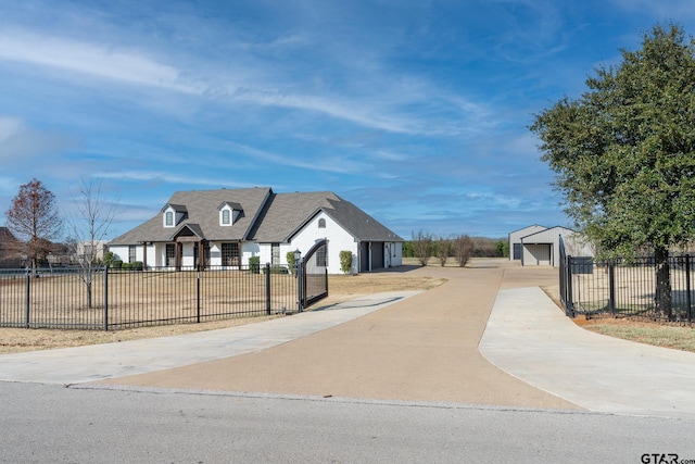 view of front of home with a garage and an outdoor structure