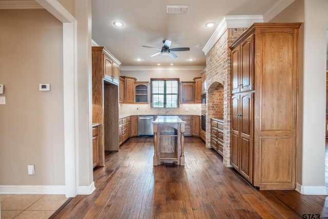 kitchen with ceiling fan, decorative backsplash, a kitchen island, crown molding, and stainless steel dishwasher